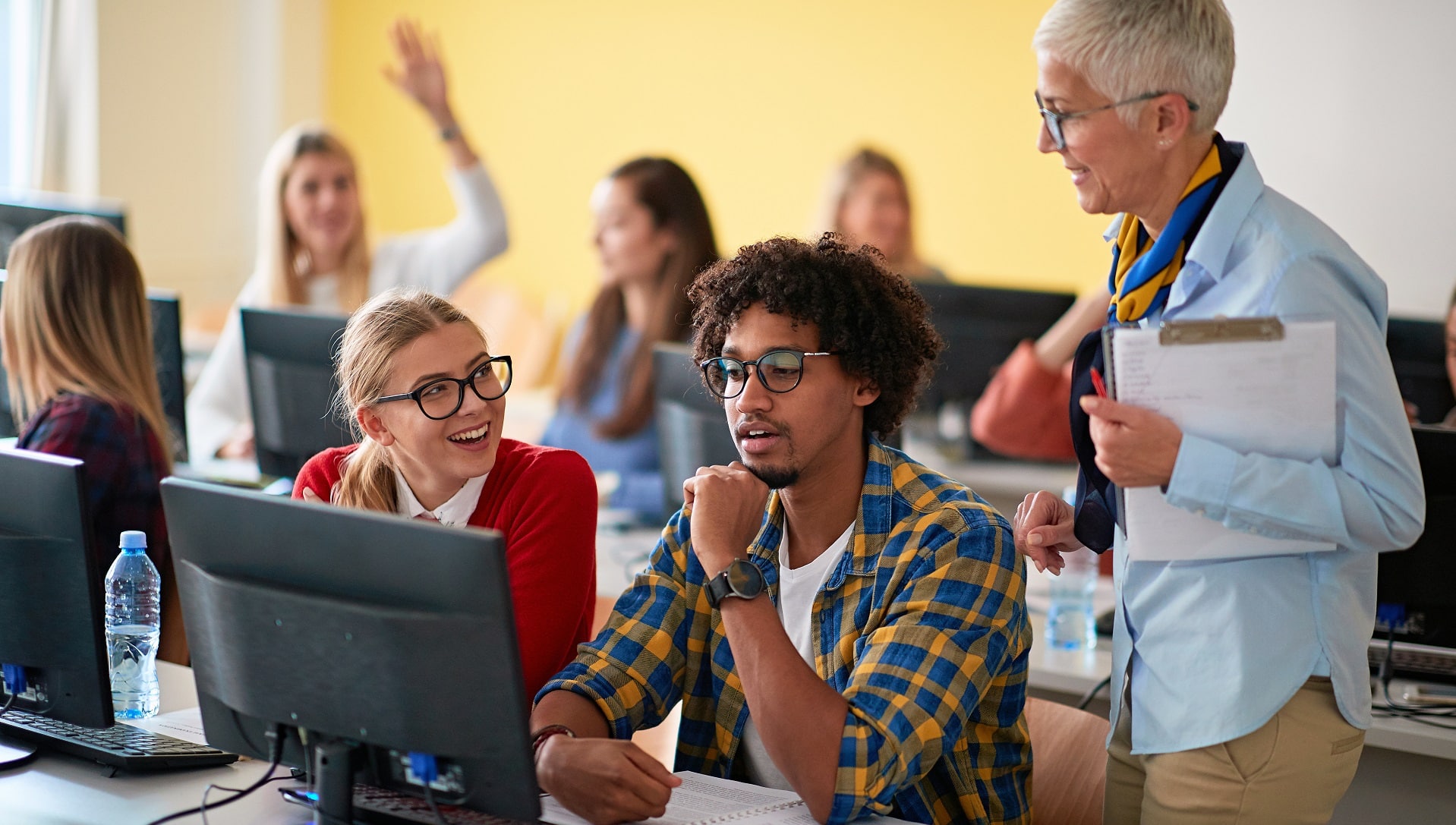 Students in classroom on computers using video captions and transcripts