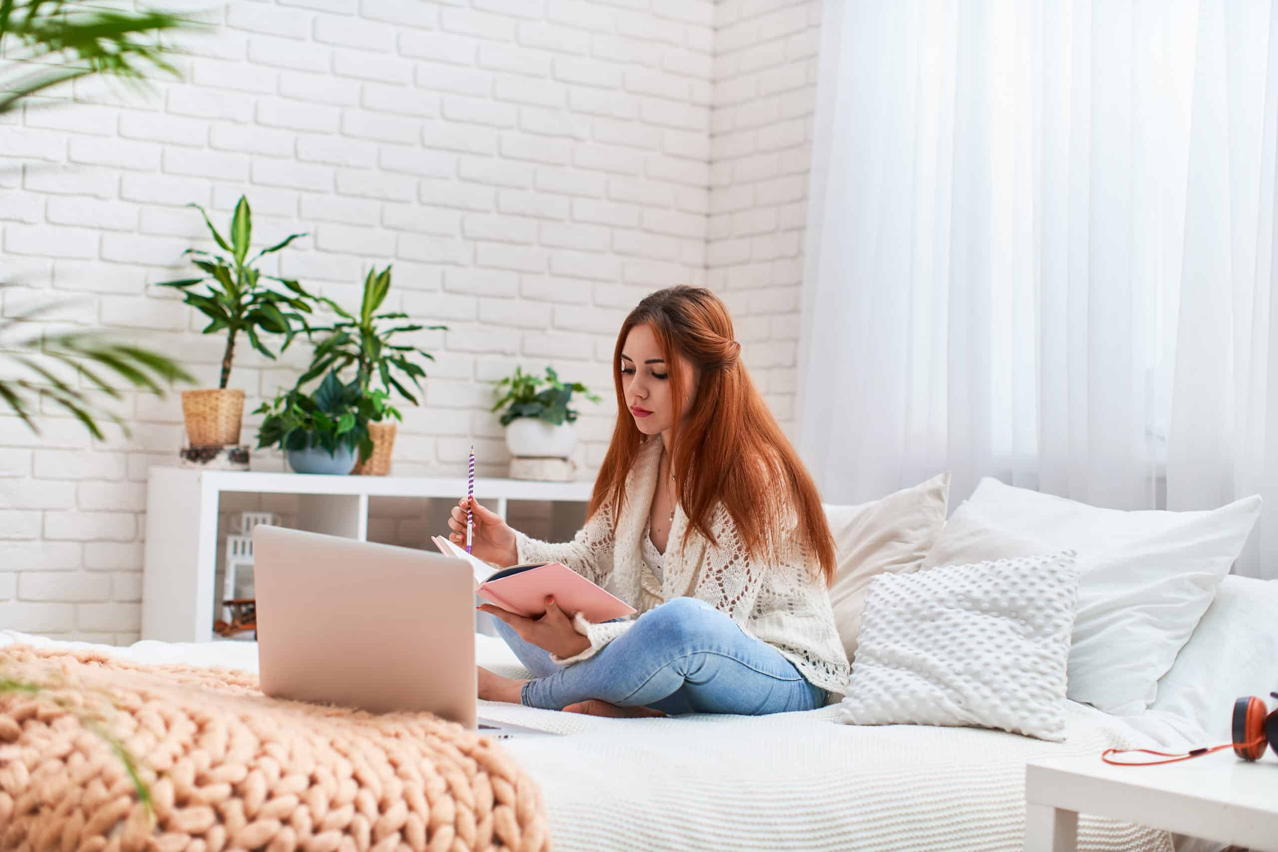 How successful is e-learning? Teen girl is studying on her bed.