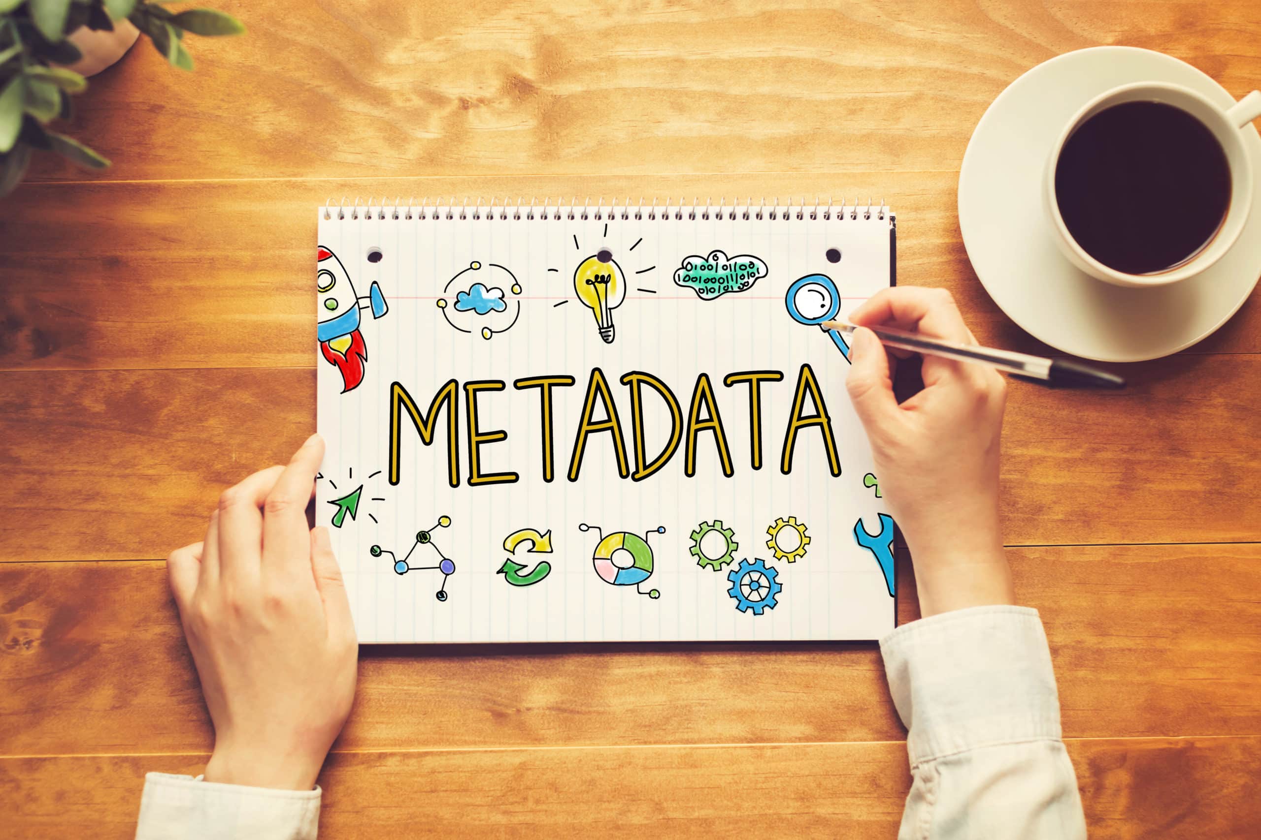 Word Metadata in education shown written on a notebook with a person holding a pen