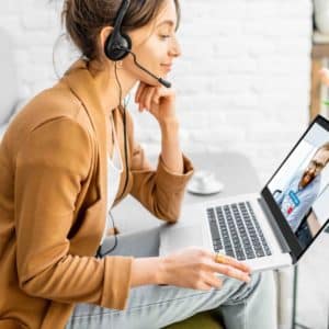 Women on video conference with laptop and headset