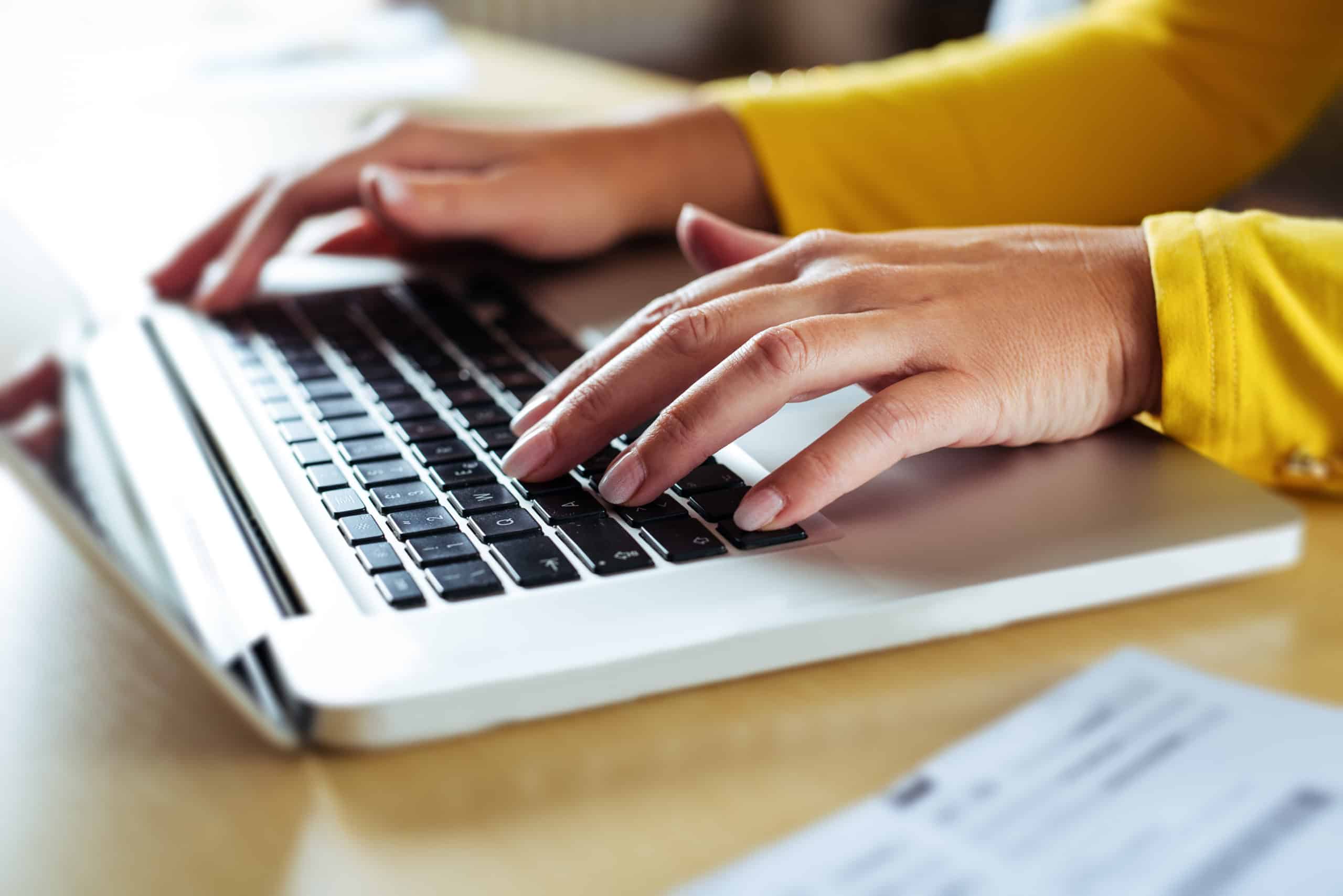 Woman typing on her laptop