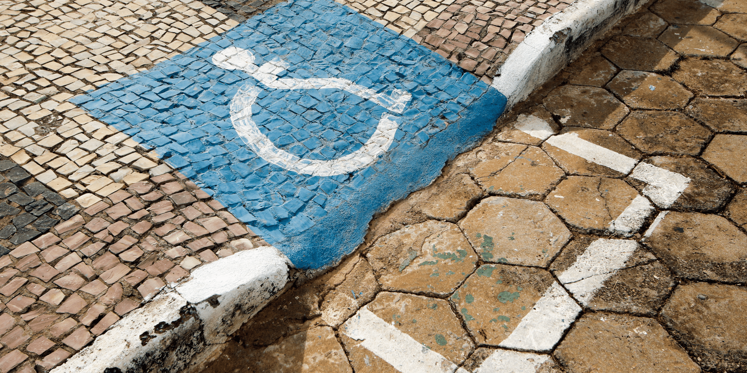 Sidewalk with accessibility sign painted on