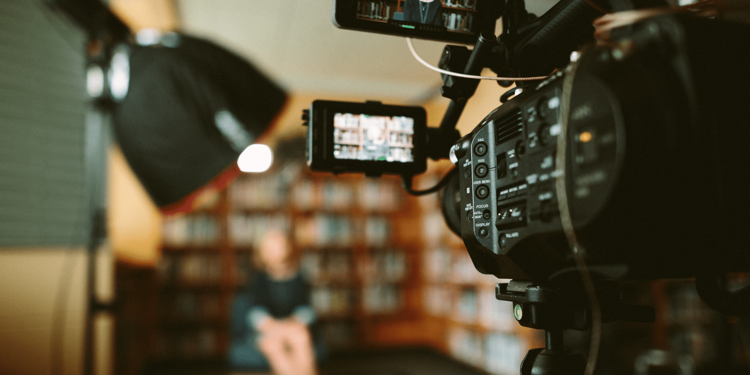 Camera filming someone in a library