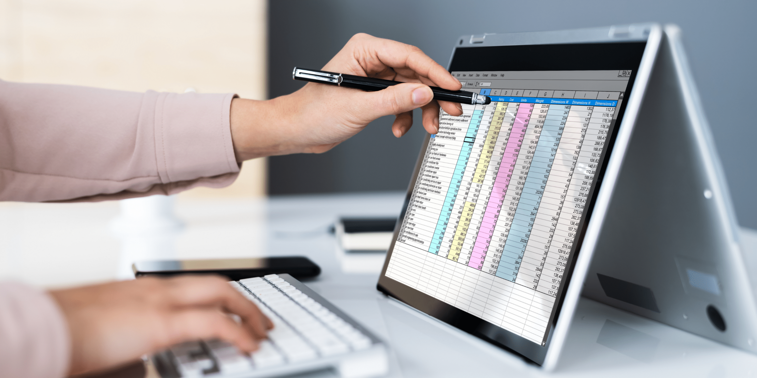 Person working on a tablet using a keyboard