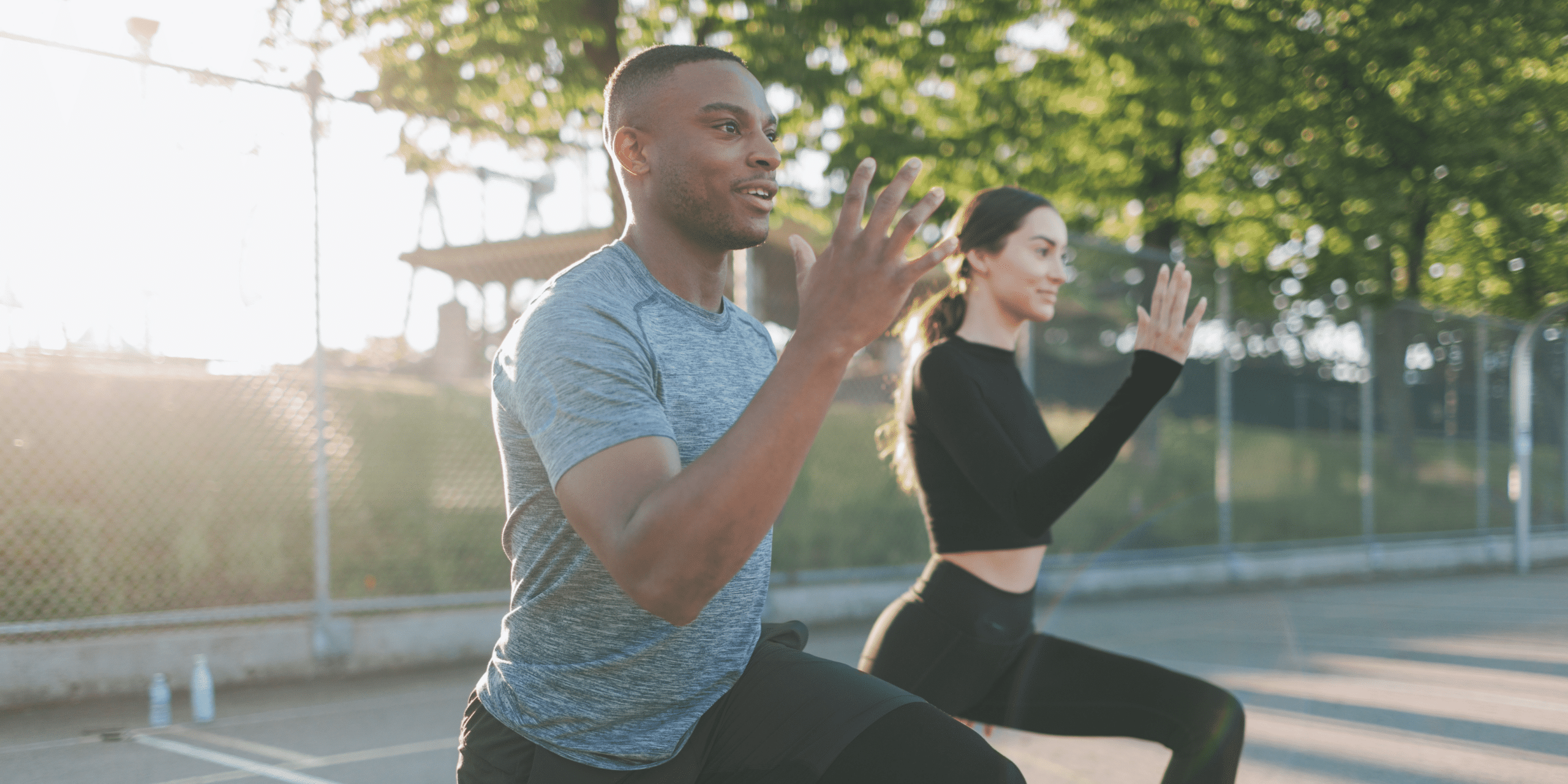 Two people working out outside