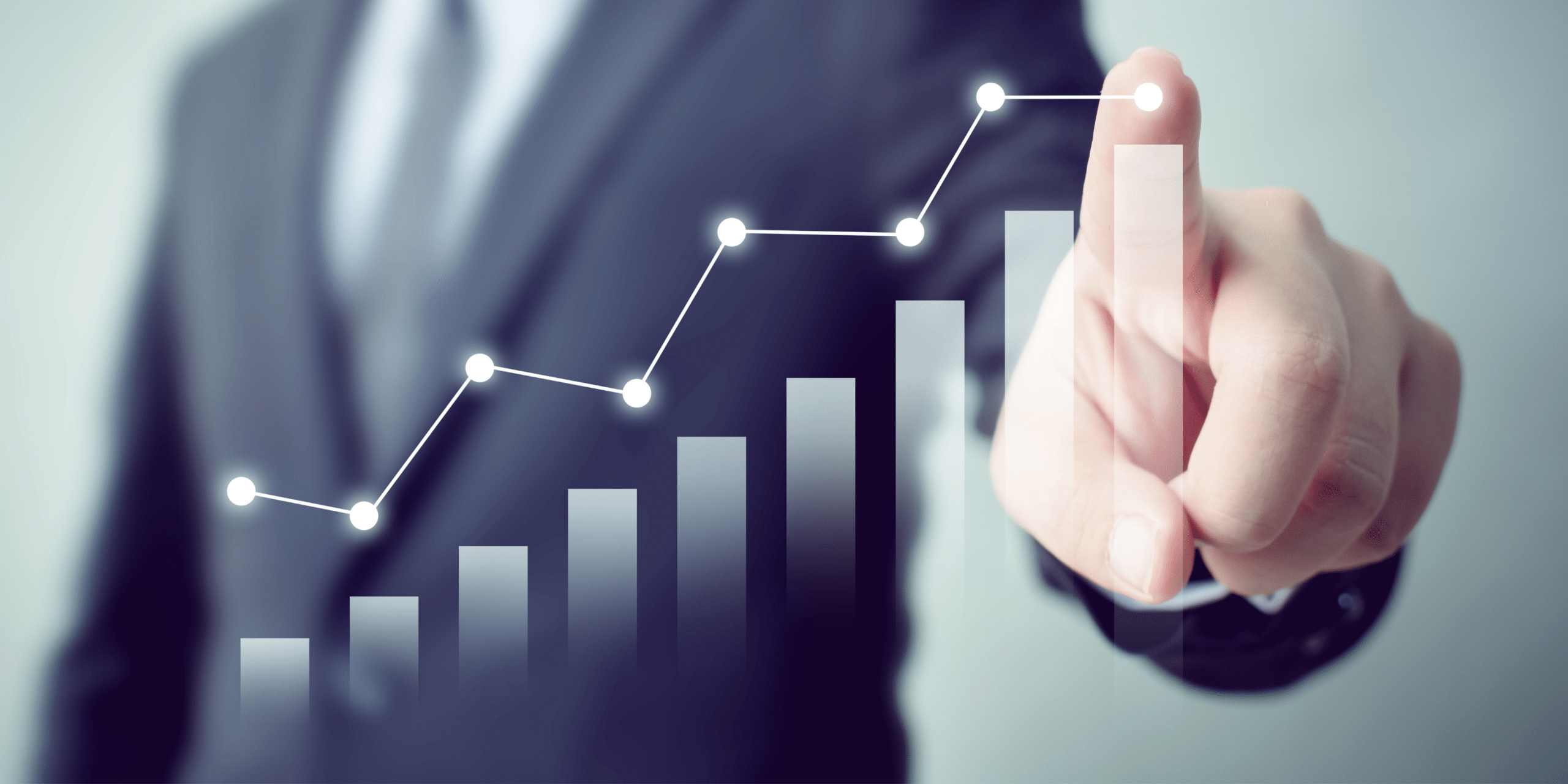 Person pointing at graph with upward trend