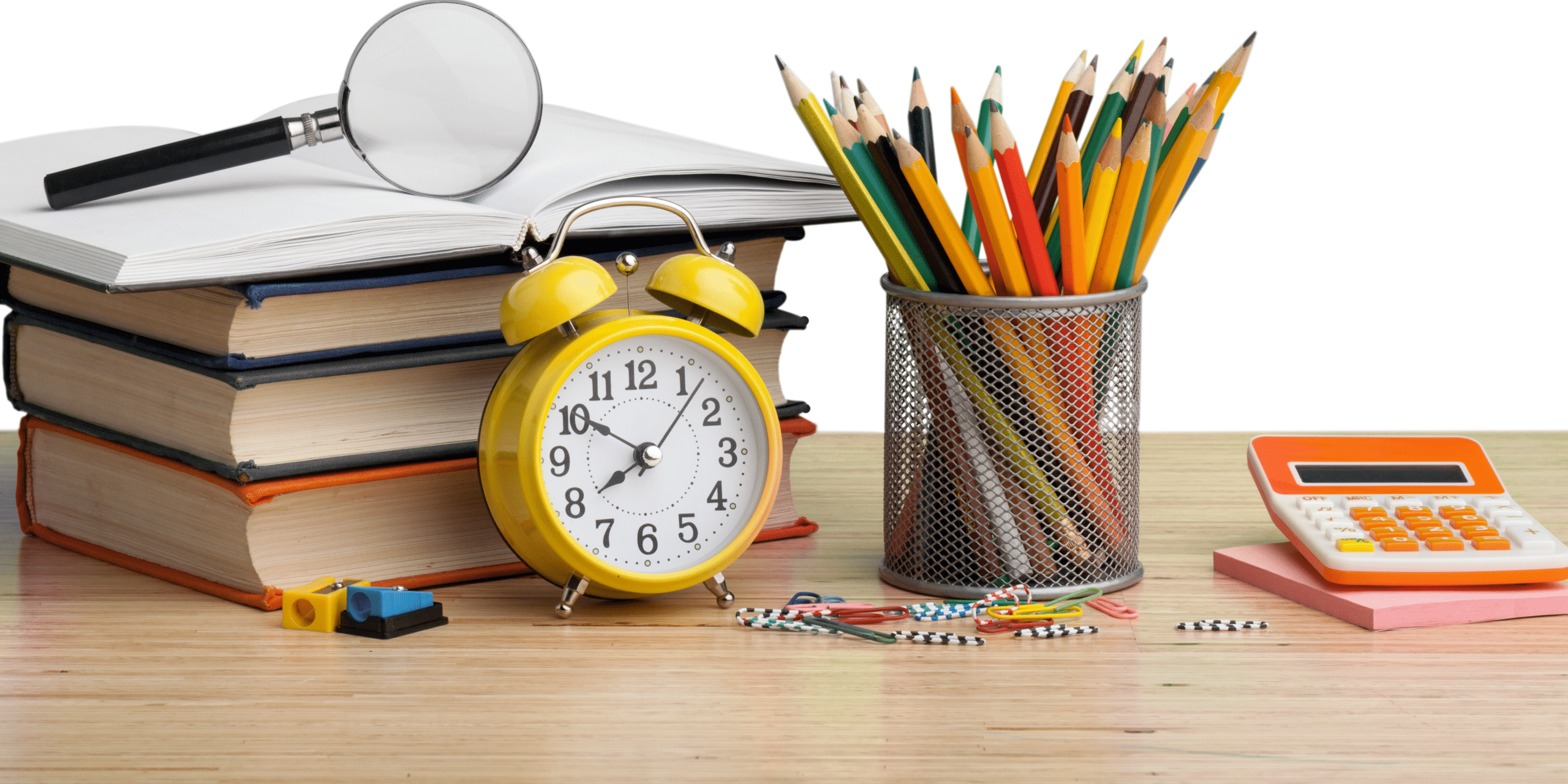 Books, clock, pencils, and a calculator on a desk.