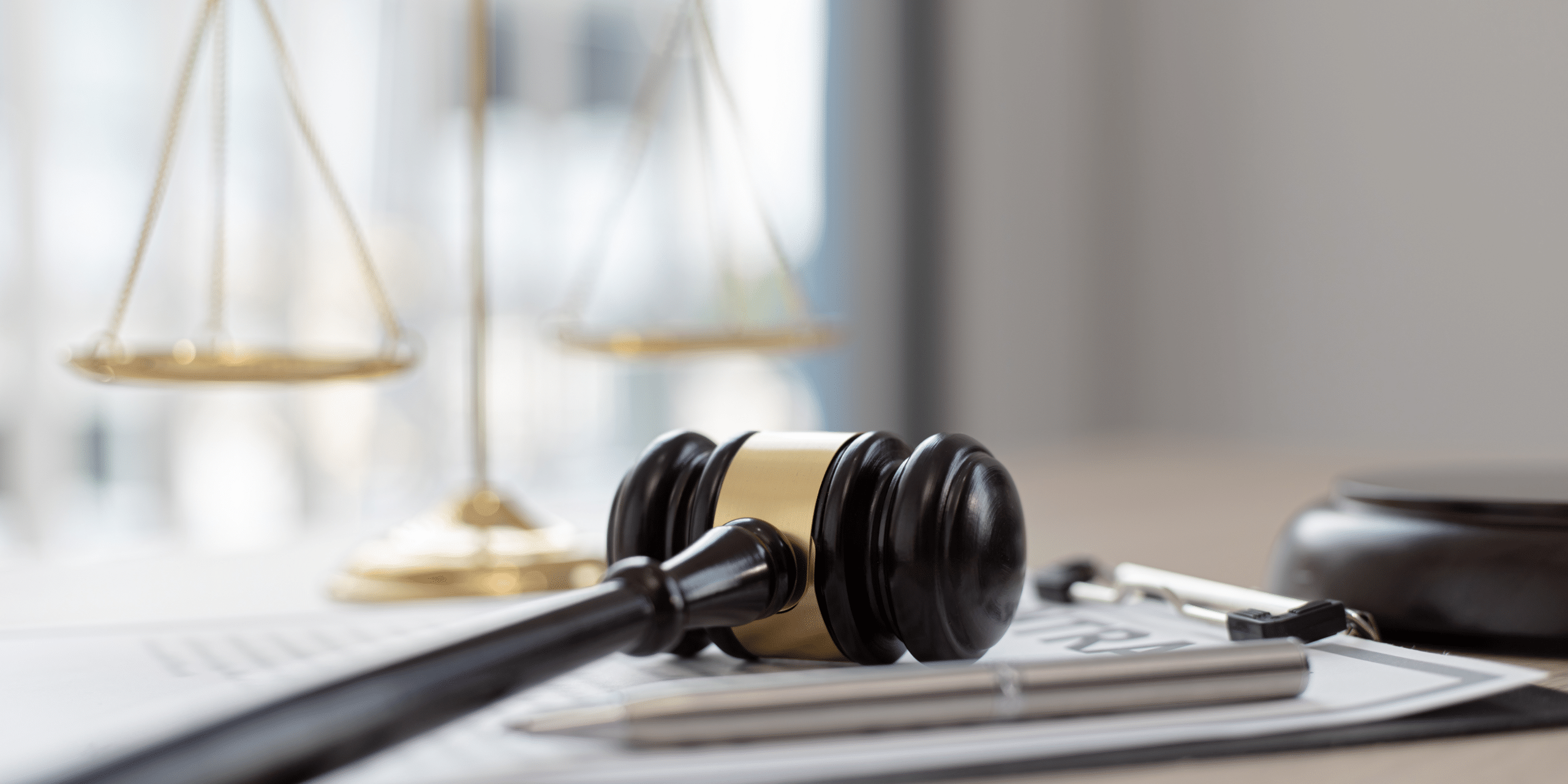 Gavel on top of papers with a scale in the background