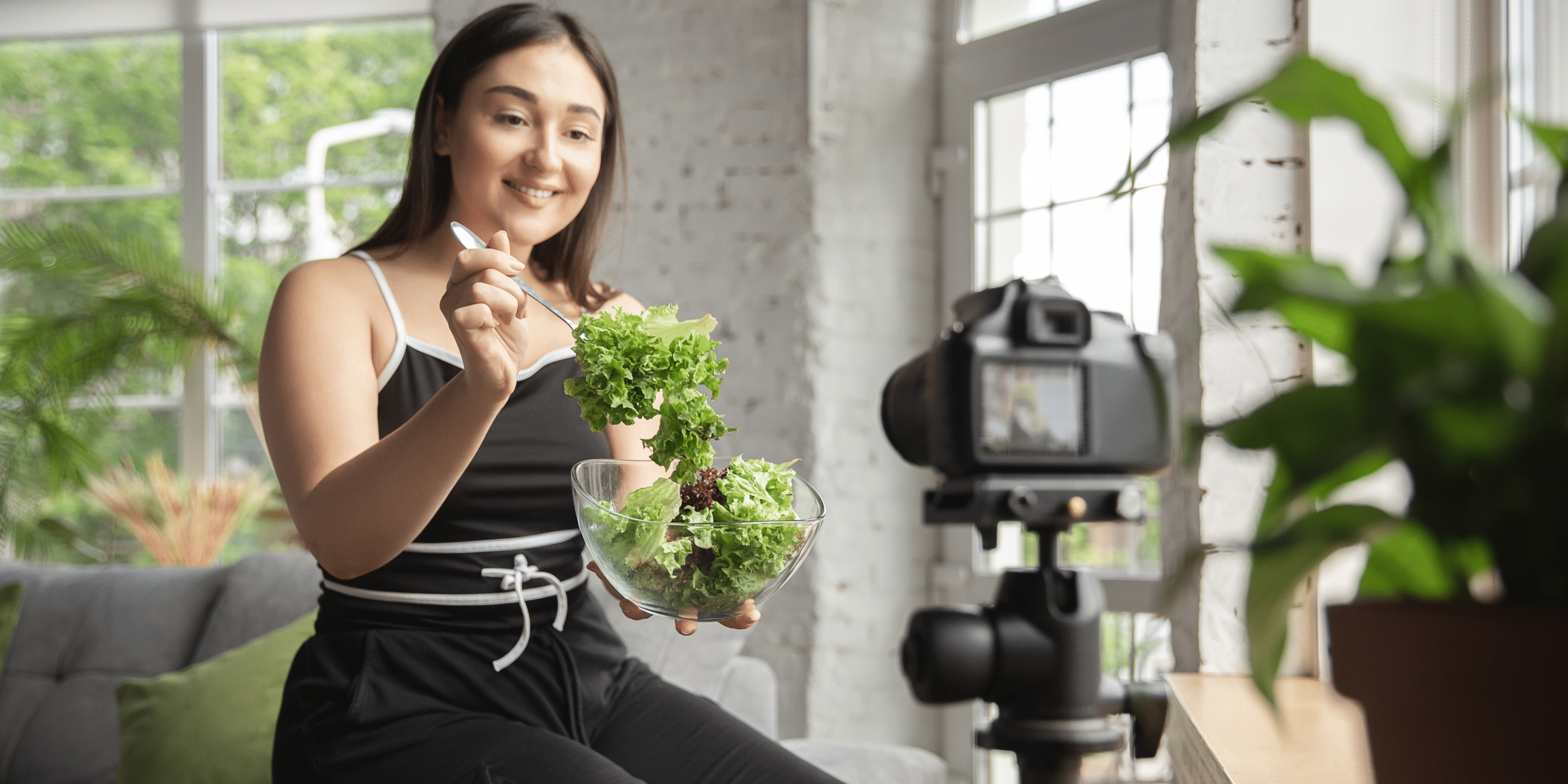 Person filming herself eating a salad