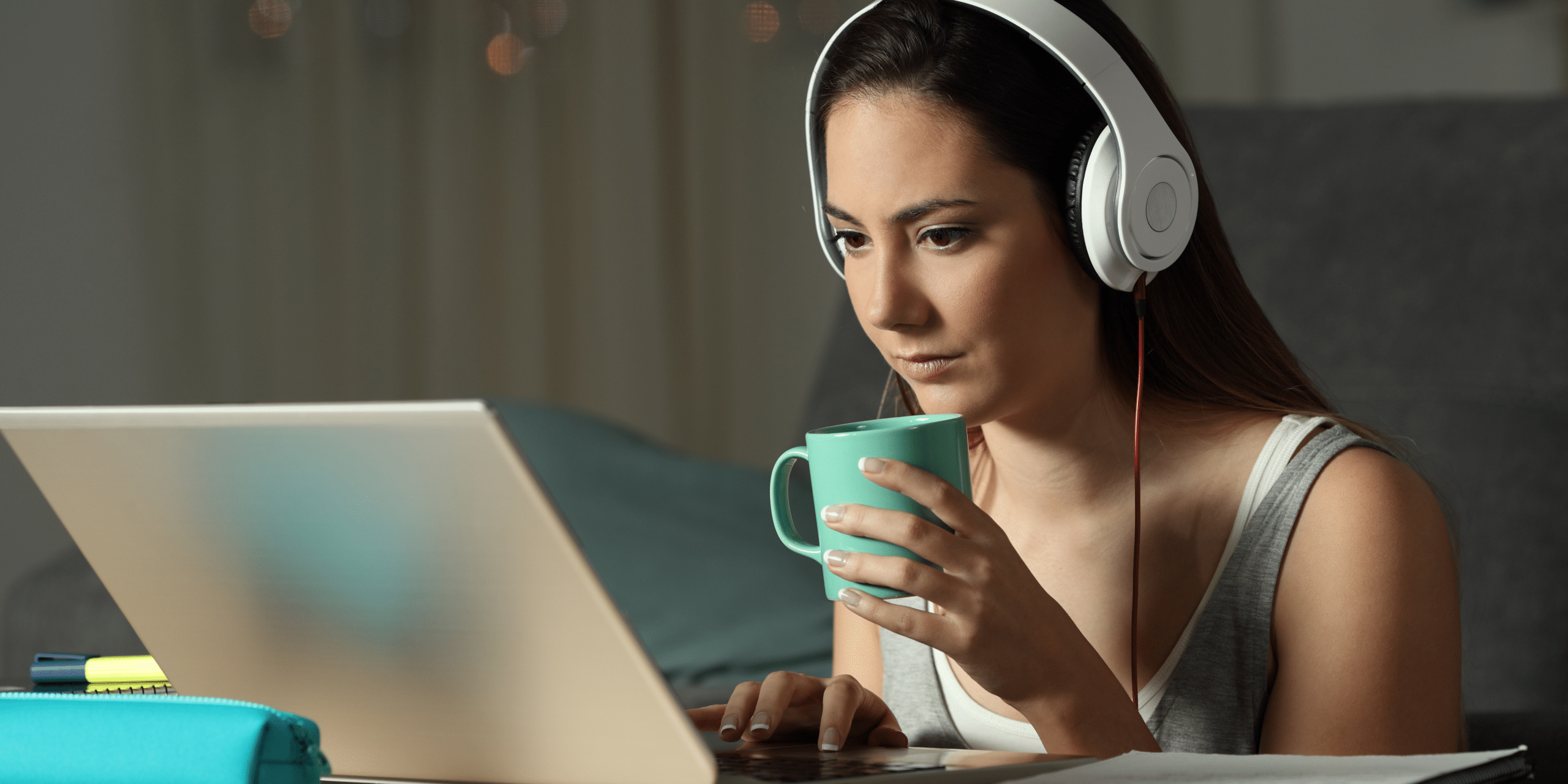 Person watching video on laptop with headphones